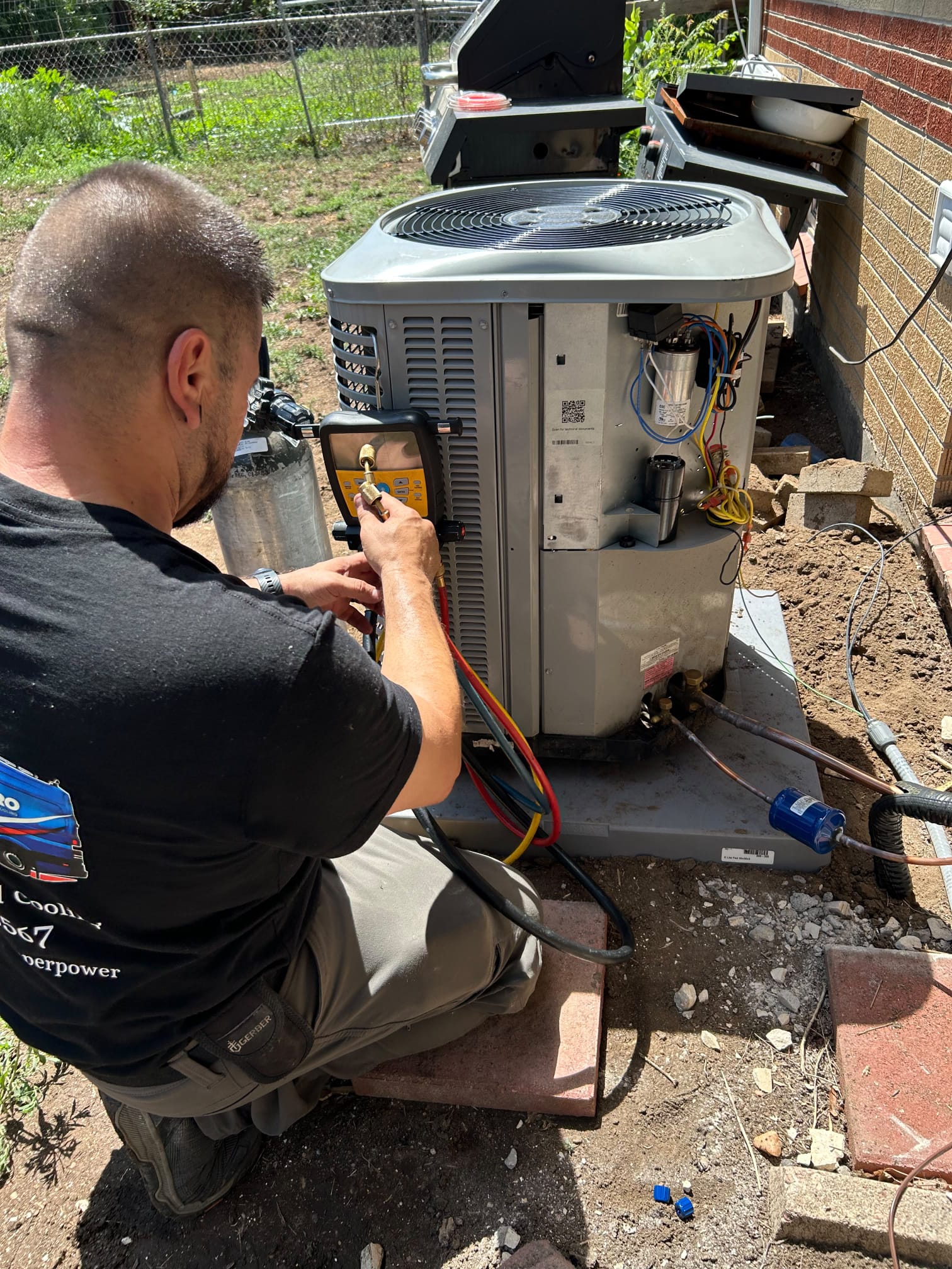 Hero Heating & Cooling technician servicing an AC condenser