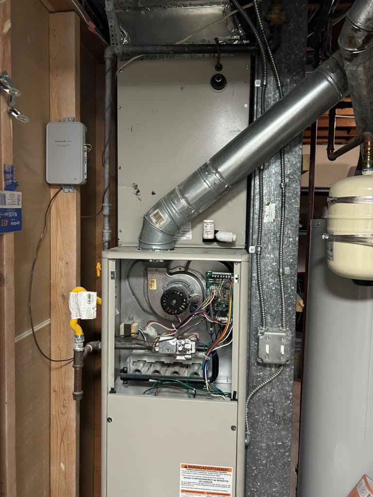 Open furnace interior showing wiring and blower access