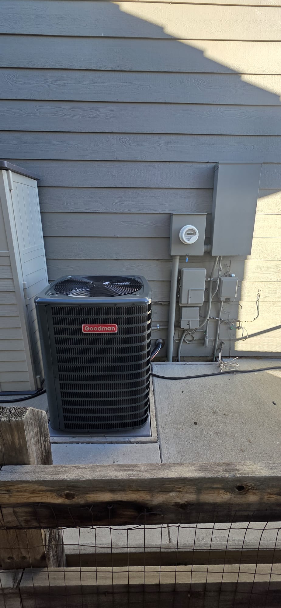 Goodman AC condenser installed outside a home
