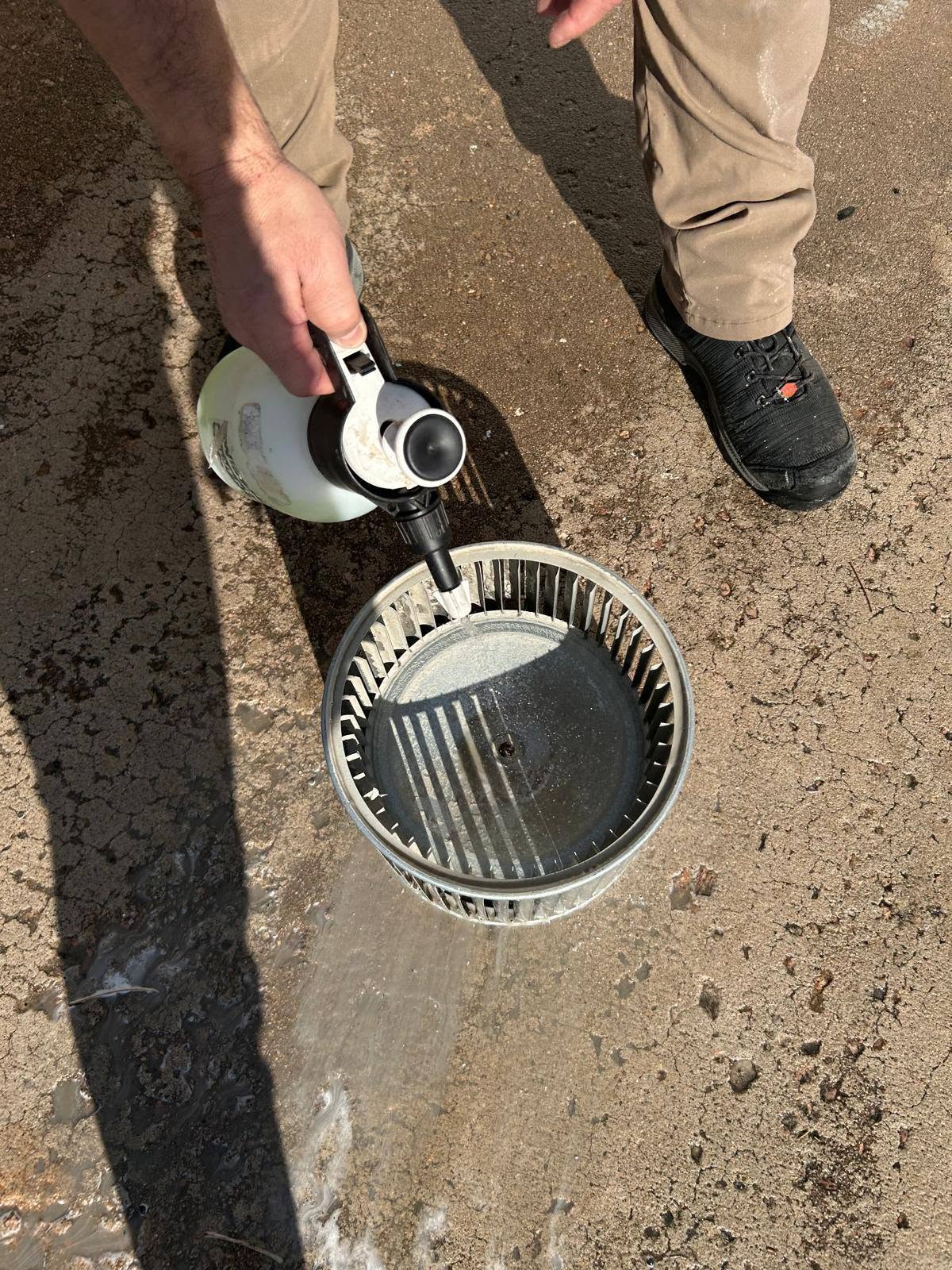 Technician cleaning a blower wheel