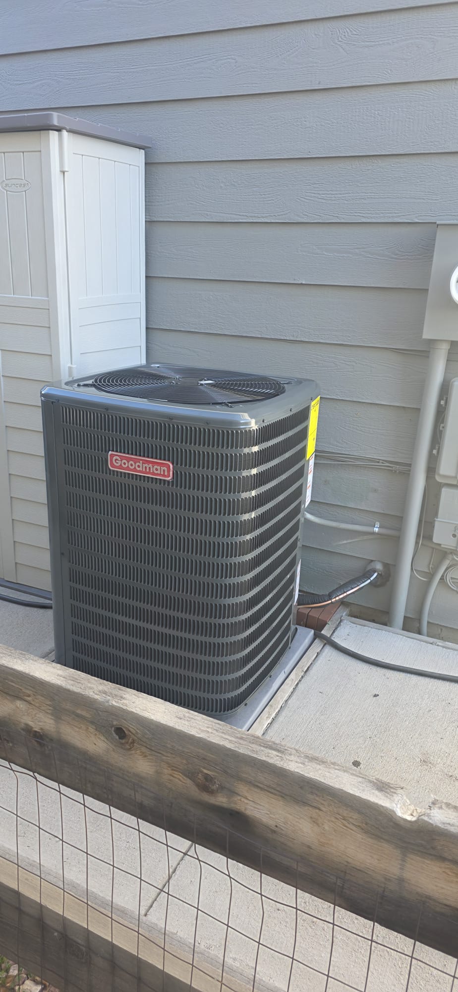 Goodman AC condenser installed outside a home